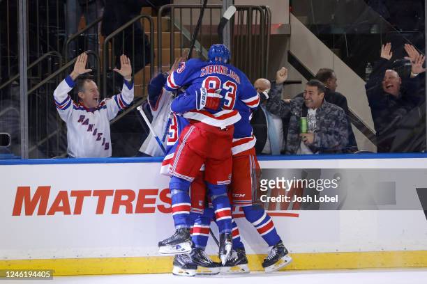 The New York Rangers celebrate after Adam Fox of the New York Rangers scores the game-winning goal in overtime to defeat the Dallas Stars 2-1 at...