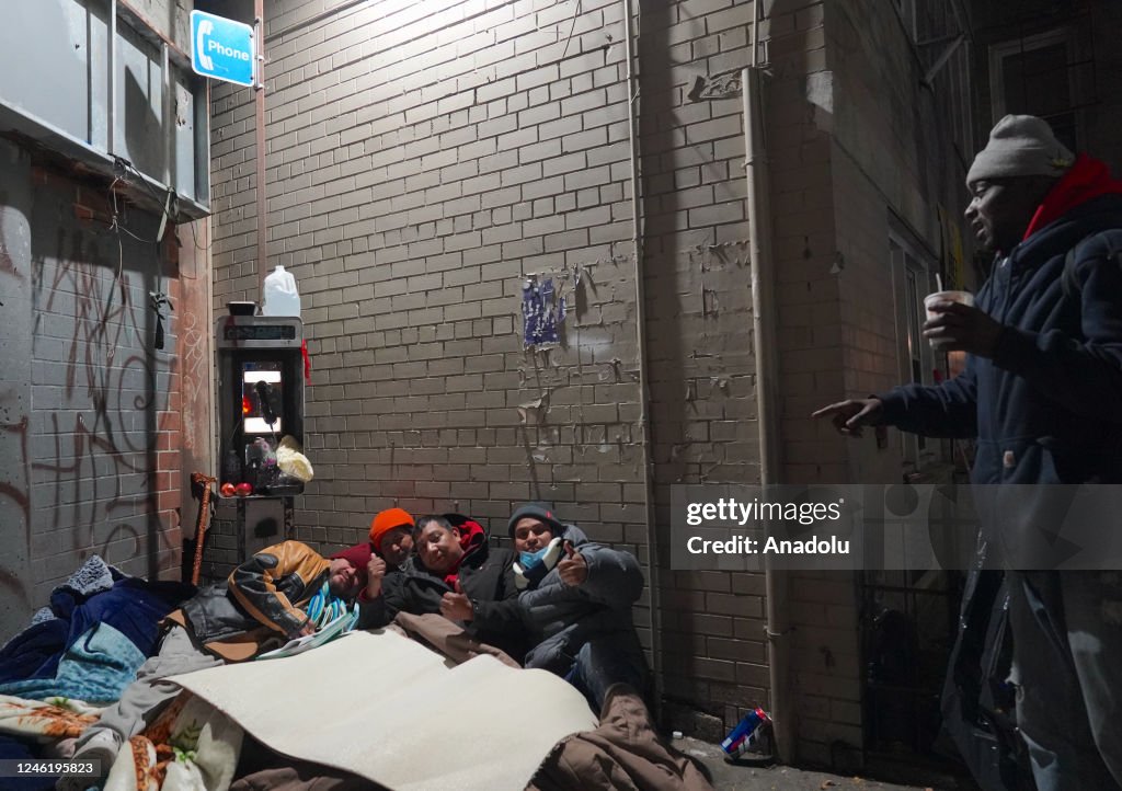 Homless In Winter A group of homeless citizens live on the sidewalk during harsh winter ...