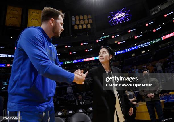 Luka Doncic of the Dallas Mavericks greets Suga, a member of the South Korean band BTS, before the game between the Los Angeles Lakers and Dallas...