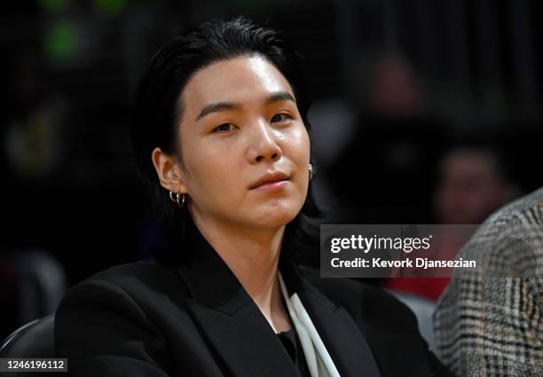 Suga, a member of the South Korean band BTS, attends the Los Angeles Lakers and Dallas Mavericks game at Crypto.com Arena on January 12, 2023 in Los...