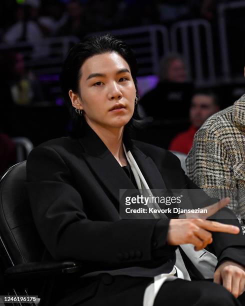 Suga, a member of the South Korean band BTS, attends the Los Angeles Lakers and Dallas Mavericks game at Crypto.com Arena on January 12, 2023 in Los...