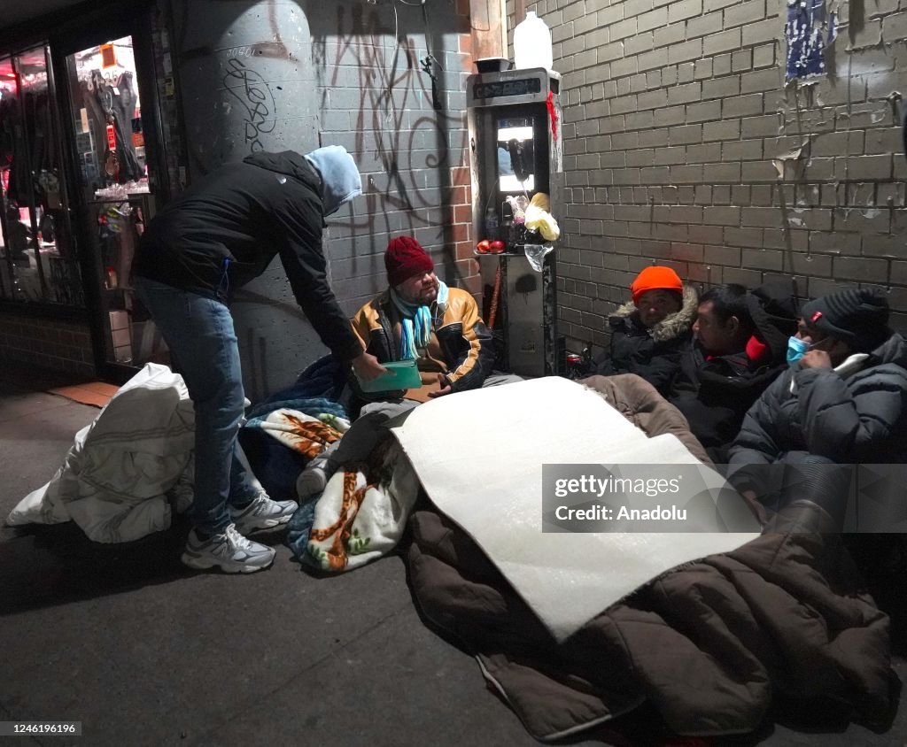 Homless In Winter A group of homeless citizens live on the sidewalk during harsh winter ...