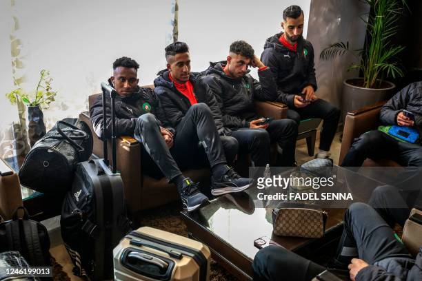 Players of the Morocco U23 football team wait at the airport of Sale, north of Morocco's capital Rabat on January 13, 2023. - Morocco's football team...