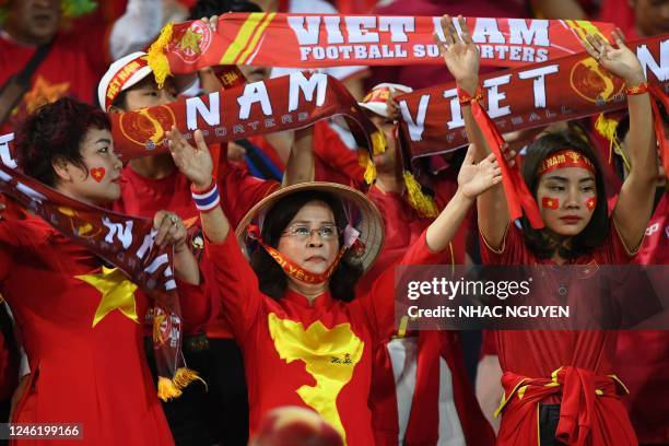 Vietnam supporters cheer on their team before the first leg of the AFF Mitsubishi Electric Cup final football match between Vietnam and Thailand at...