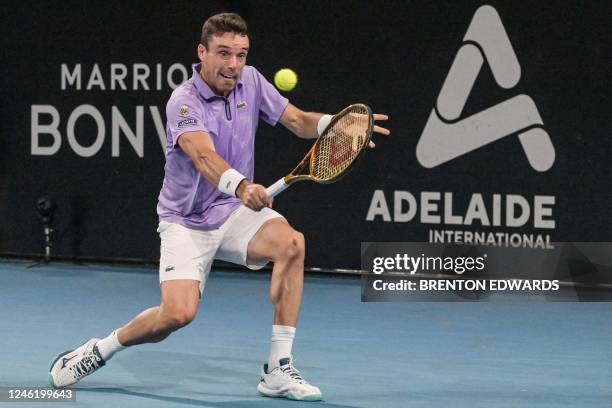 Spanish tennis player Roberto Bautista Agut hits a return during his semi-final match against Australian Thanasi Kokkinakis at the ATP Adelaide...