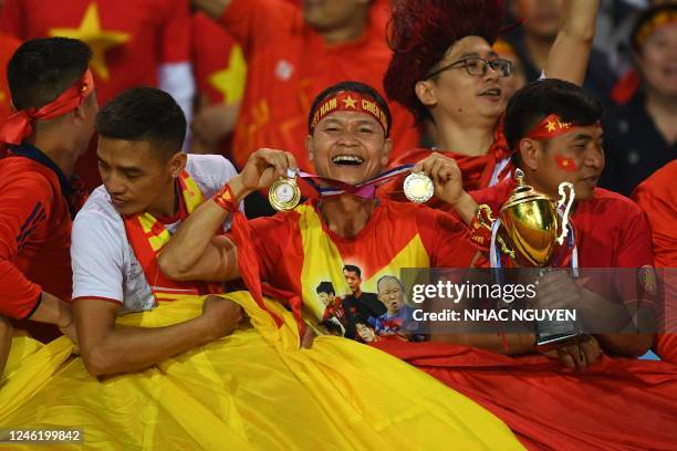 Vietnam supporters cheer on their team ahead of the first leg of the AFF Mitsubishi Electric Cup final football match between Vietnam and Thailand at...