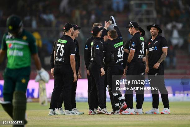 New Zealand's players celebrate the dismissal of Pakistan's Fakhar Zaman during the third and final one-day international cricket match between...