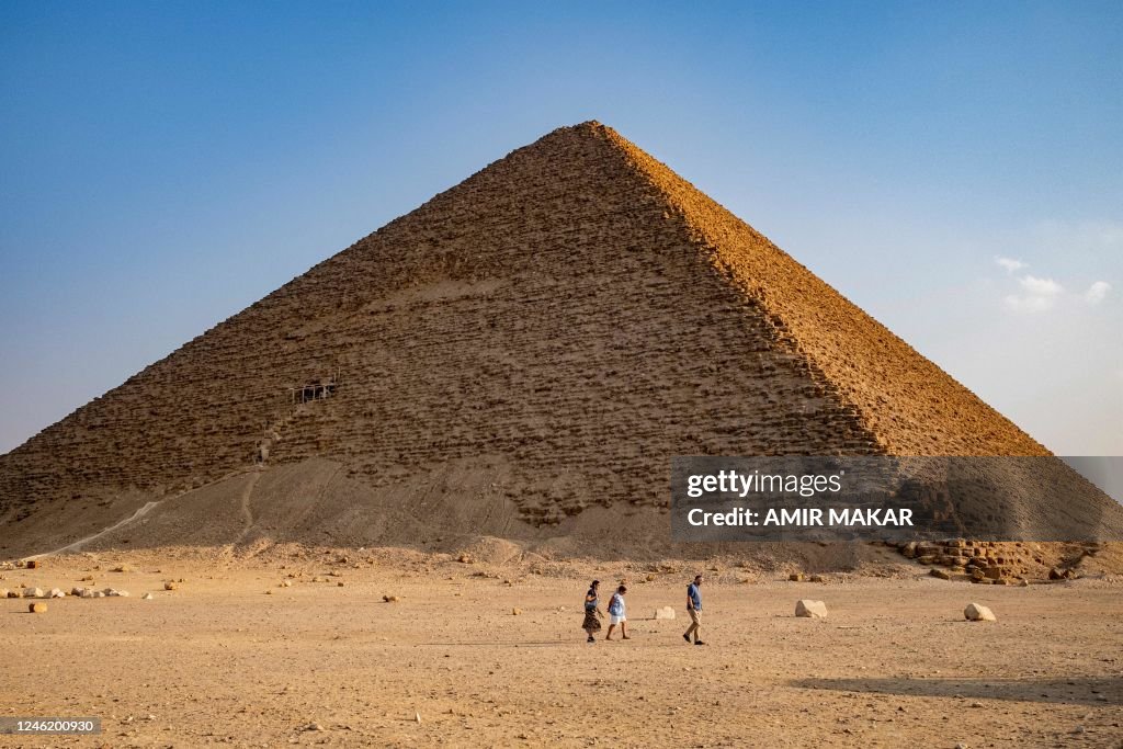 Pyramid Outside Tourists walk outside the Red Pyramid of the ancient Egyptian Old ...