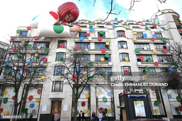 This photo taken on January 13 shows a large inflatable mannequin depicting Japanese contemporary artists Yayoi Kusama decorating the French luxury...