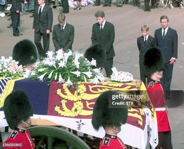 From the left, Prince William, Earl Spencer, Prince Harry and Prince Charles approach the gun carriage with the coffin of Diana, Princess of Wales in...