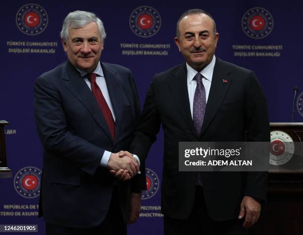 Turkish Foreign Minister Mevlut Cavusoglu and Antonio Tajani, Deputy Prime Minister and Minister of Foreign Affairs of Italy shake hands as they hold...