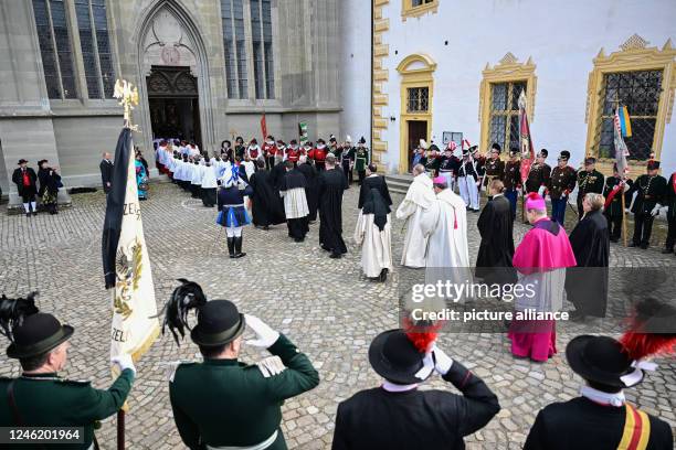 January 2023, Baden-Wuerttemberg, Salem: Clergymen walk past groups of costumed people into the minster during the funeral service. The funeral...