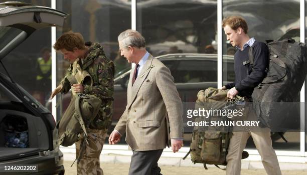 Britains Prince Harry is met by his brother, Prince William , and his father Prince Charles on his arrival at RAF Brize Norton in Oxforshire March 1...