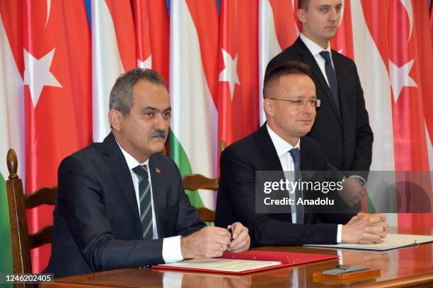 Turkish Minister of National Education Mahmut Ozer and Hungarian Foreign and Trade Minister Peter Szijjarto pose for a photo after signing Stipendium...