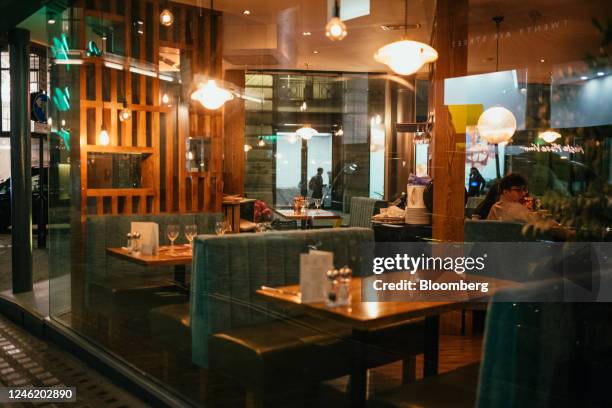 Empty tables inside a restaurant in the Soho district in London, UK, on Thursday, Jan. 12, 2023. Britain's pubs and restaurants are cutting their...