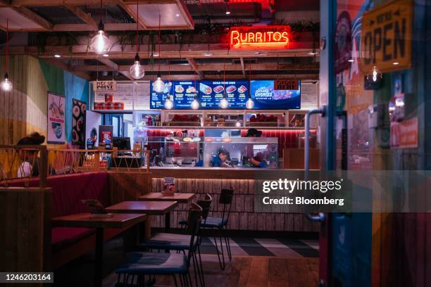 Empty tables inside a burritos takeaway in the Soho district of London, UK, on Thursday, Jan. 12, 2023. Britain's pubs and restaurants are cutting...