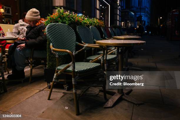 Empty tables on the sidewalk outside a restaurant in central London, UK, on Thursday, Jan. 12, 2023. Britain's pubs and restaurants are cutting their...