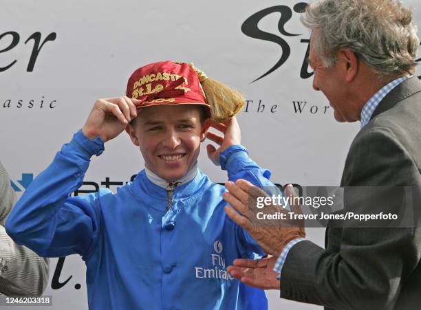 Australian Jockey Kerrin McEvoy receiving the ceremonial cap for winning the St Leger riding Rule of Law at Doncaster, 11th September 2004.