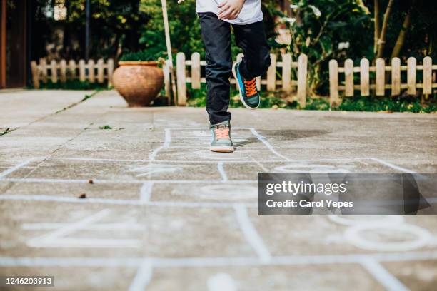 playing hopscotch in the playground. - hopscotch stock pictures, royalty-free photos & images