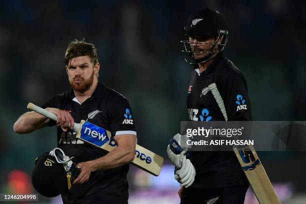 New Zealand's Glenn Phillips and his teammate Tim Southee walk back to the pavilion after their victory on the third and final one-day international...