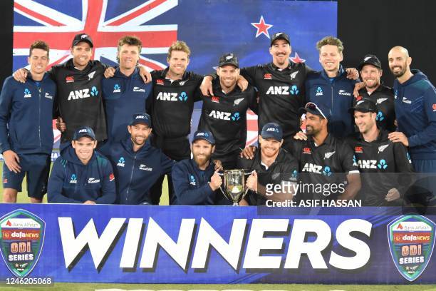 New Zealands players pose with the winners' trophy on the third and final one-day international cricket match between Pakistan and New Zealand at the...
