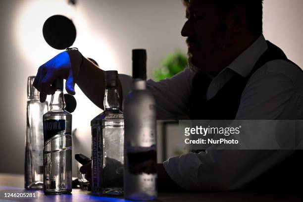 Tour guide holds a bottle of vodka at the Vodka Museum in Warsaw, Poland on 13 January, 2022.