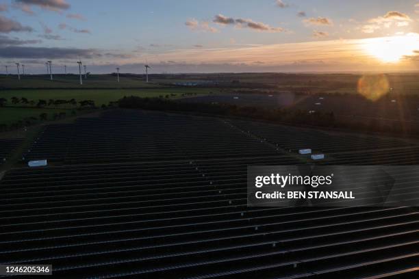 An aerial view shows wind turbines in the countryside, and the photovoltaic solar panels making up the Great Wilbraham Solar Park, near Fulbourn,...