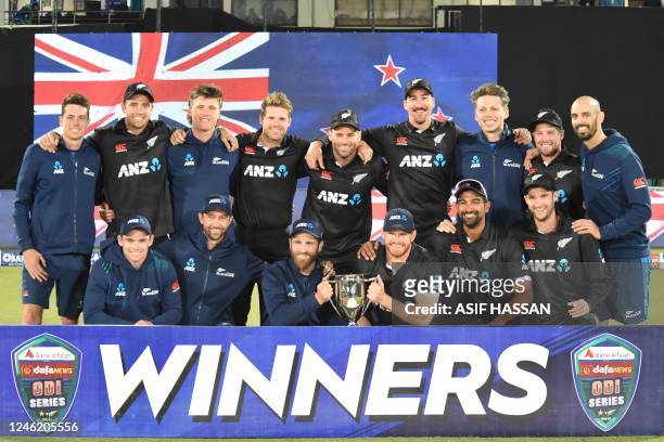 New Zealands players pose with the winners' trophy on the third and final one-day international cricket match between Pakistan and New Zealand at the...