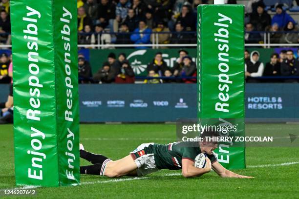 Leicester Tigers' Scottish centre Matt Scott dives across the line to score his team's first try during the European Rugby Champions Cup pool B rugby...