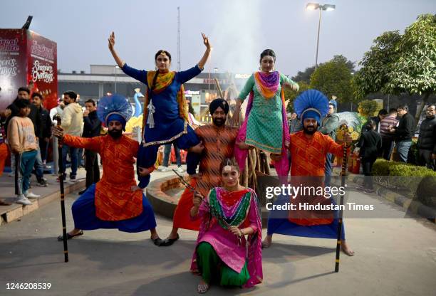 Group of dancers from Punjab performs during the Lohri celebrations at Great India Place Mall sector 38A on January 13, 2023 in Noida, India. Lohri...
