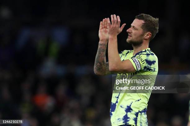 Leeds United's English-born Scottish defender Liam Cooper applauds fans after the English Premier League football match between Aston Villa and Leeds...