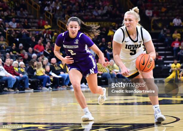 Iowa guard Sydney Affolter drives to the basket as Northwestern guard Caroline Lau defends during a women's college basketball game between the...