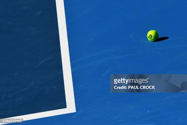Tennis ball is seen on the court during the training and practice session ahead of the Australian Open tennis tournament in Melbourne on January 14,...