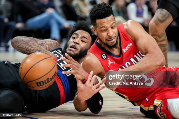 Saddiq Bey of the Detroit Pistons and CJ McCollum of the New Orleans Pelicans fight for the ball during the second quarter of the game at Little...