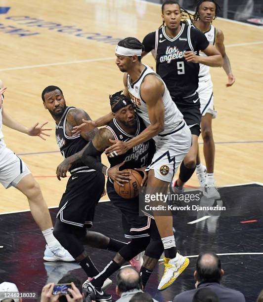 Robert Covington of the Los Angeles Clippers is fouled by Zeke Nnaji of the Denver Nuggets during the second half at Crypto.com Arena on January 13,...