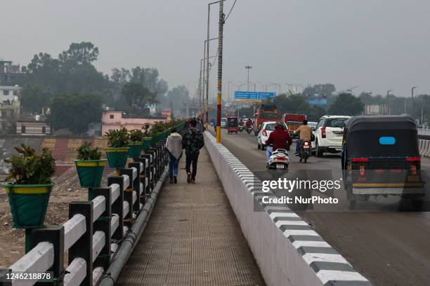 Couple walks over Tawi bridge on a cloudy day in Jammu City Jammu and Kashmir India on 13 January 2023