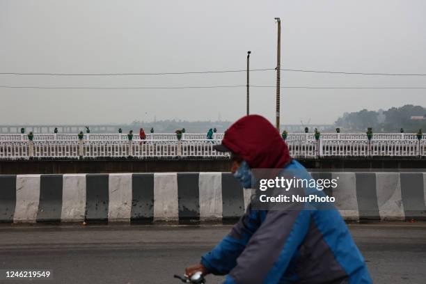 People walk over Tawi bridge on a cloudy day in Jammu City Jammu and Kashmir India on 13 January 2023