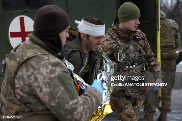 Medics of Ukrainian Army evacuate a wounded soldier on a road not far of Soledar, Donetsk region on January 14 amid the Russian invasion of Ukraine....