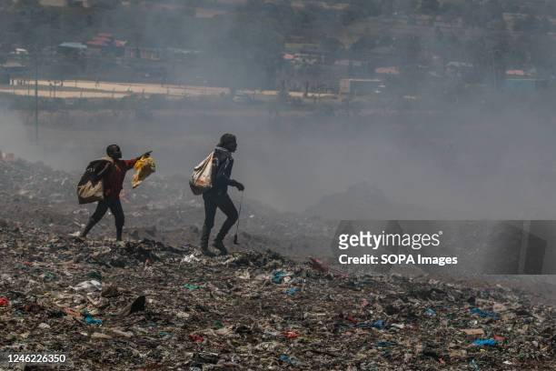 Young waste pickers recover waste for recycling amidst heavy smoke from burning garbage at the Nakuru main dumping yard. Since waste is rarely...
