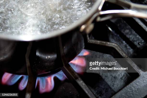 January 12: In this photo illustration a pot with boiling water sits on flames burning on a natural gas burning stove on January 12, 2023 in NORTH...