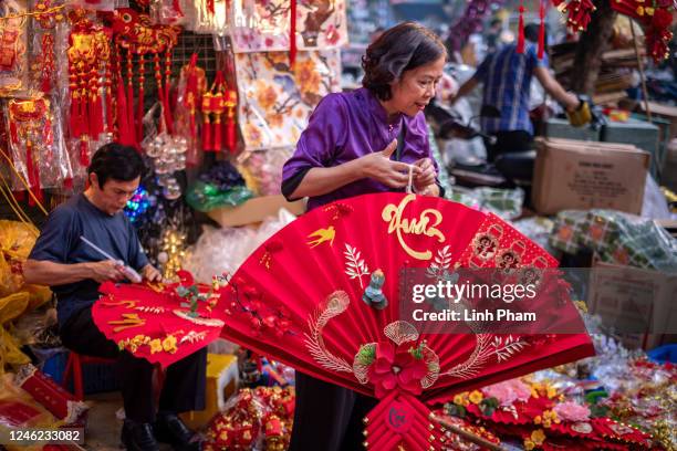 Vendors prepare their Lunar New Year decoration items at the Spring Festival Fair in the Old Quarter on January 14, 2023 in Hanoi, Vietnam. The Lunar...