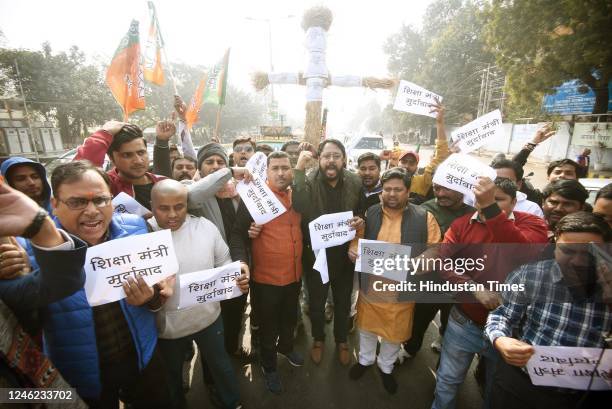 Members of Bharatiya Janata Yuva Morcha demonstrating with effigy of Bihar Education Minister Prof. Chandrashekhar over his comments on holy...