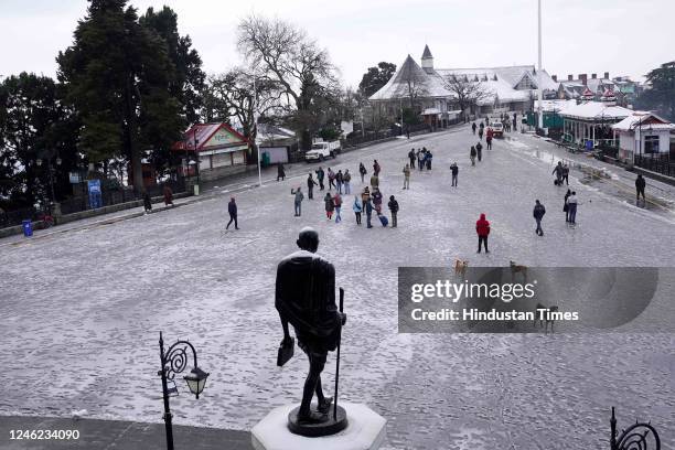 Tourists take a stroll in the snow covered Ridge after the fresh snowfall, on January 14, 2023 in Shimla, India.