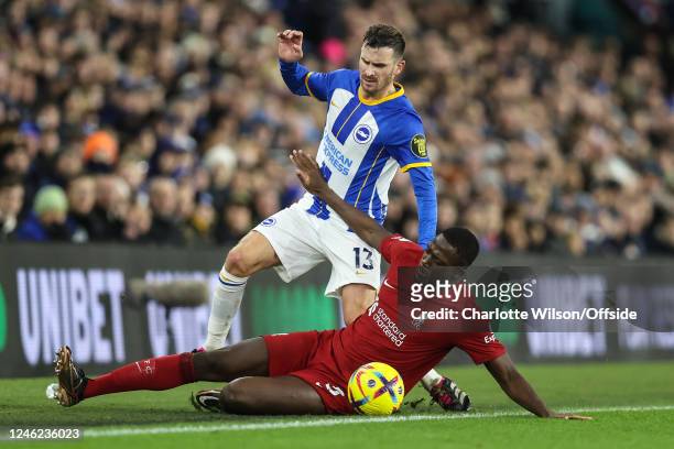 Pascal Gross of Brighton & Hove Albion and Ibrahima Konate of Liverpool take the ball off the pitch during the Premier League match between Brighton...