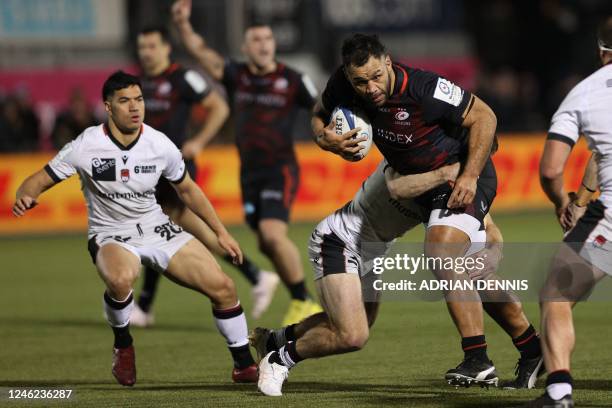 Saracens' English number 8 Billy Vunipola is tackled during the European Rugby Champions Cup pool A rugby union match between Saracens and Lyon at...