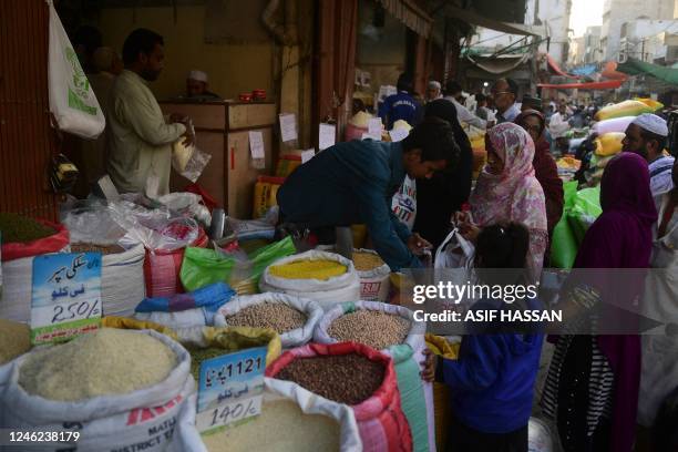 In this picture taken on January 10 people buy grocery items at a main wholesale market in Karachi. - Pakistan's usually bustling ports have ground...