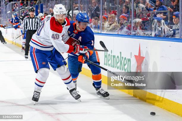 Joel Armia of the Montreal Canadiens and Josh Bailey of the New York Islanders battle for the puck during the first period at UBS Arena on January...