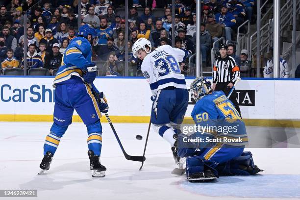 Nick Leddy and Jordan Binnington of the St. Louis Blues defend the net against Brandon Hagel of the Tampa Bay Lightning at the Enterprise Center on...