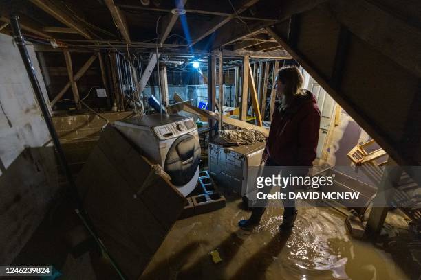 Amberlee Galvin stands in her flooded basement in Felton, California, on January 14 as a series of atmospheric river storms continues to cause...