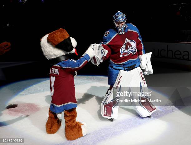 Goaltender Pavel Francouz of Colorado Avalanche high fives Lil Bern after being named First Star of the Game against the Ottawa Senators during Next...
